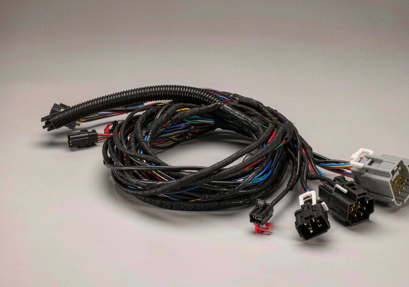 Automotive wiring harness with taped loom and multi-pin connectors